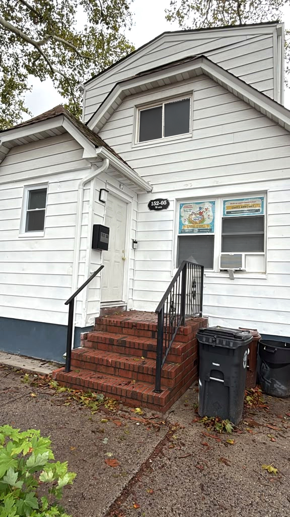 The Learning Nest's colorful business signs in the front windows, beside the entrance at 152-05 79th Avenue.
